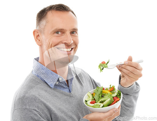 Image of Portrait, food and diet with a man in studio isolated on a white background eating vegetables for health. Green, nutrition and health with a mature male indoor to eat an organic salad for wellness