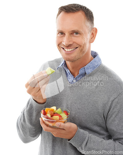 Image of Happy man with fruit salad isolated on a white background for healthy green lunch, diet choice or nutritionist breakfast. Professional vegan person or model eating fruits, food or apple in studio