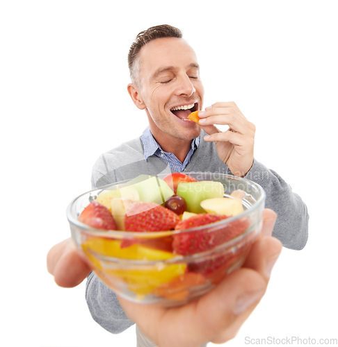 Image of Happy man eating fruits isolated on a white background for healthy green lunch, diet offer or nutritionist breakfast. Professional vegan person or model giving fruits salad, food or peach in studio