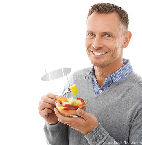 Image of Portrait, studio and happy man eating fruit salad for healthy snack, diet meal or craving. Happiness, smile and male model enjoying fresh produce for health and wellness isolated by white background.