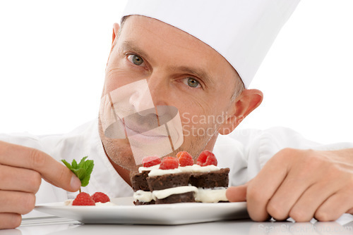 Image of Fruit, baking and portrait of a chef with cake presentation isolated on a white background in a studio. Smile, food and face of a professional baker with a sweet chocolate dessert for catering