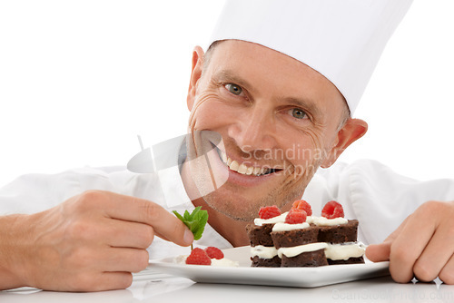 Image of Bakery, baking and portrait of a chef with cake presentation isolated on a white background in a studio. Fruit, food and face of a professional baker with a sweet chocolate dessert for catering