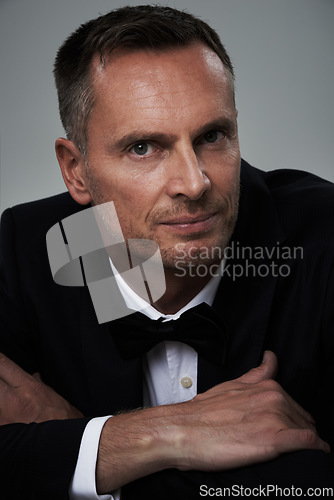 Image of Studio portrait of mature man, tuxedo and handsome, serious and isolated on grey background. Luxury, glamour and wealth, success with celebrity actor style, elegant and sexy date for valentines day.