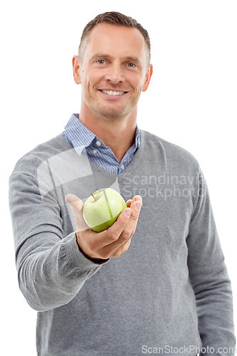 Image of Giving apple, studio portrait and man with fruit for health, diet and wellness isolated on a white background. Model person with nutrition vegan food in hand for healthy lifestyle and clean eating