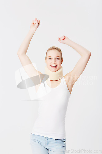 Image of Happy, neck brace and portrait of a woman with freedom isolated on a white background. Smile, excited and girl with arms up for accident insurance, healthcare and medical attention with whiplash