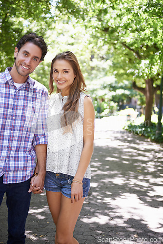 Image of Bonding couple, portrait or holding hands in park, nature or garden walk on valentines day date, romance love or summer break. Smile, happy man or woman in relax trust, partnership or safety support