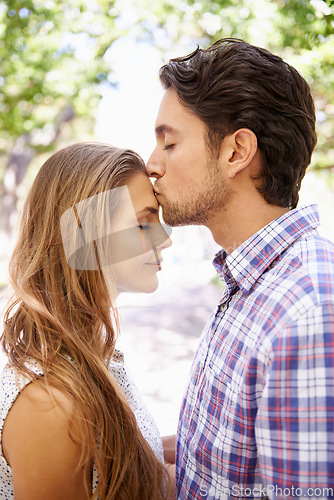 Image of Couple, bonding and forehead kiss on love date, valentines day or romance in nature break, park or relax garden. Man, happy woman or kissing head in intimate trust, security hug and thank you support