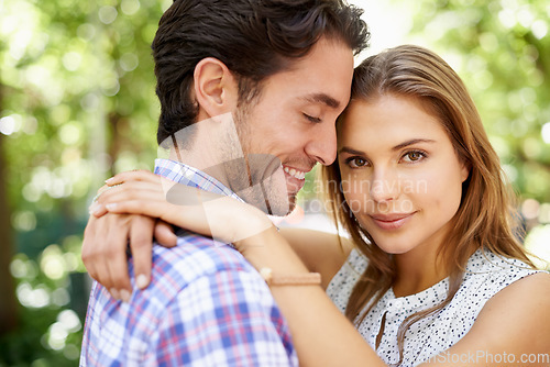 Image of Couple portrait, hug or bonding in park, nature or garden on valentines day date, romance love or holiday. Smile, happy man or woman in embrace, relax trust or partnership support for profile picture