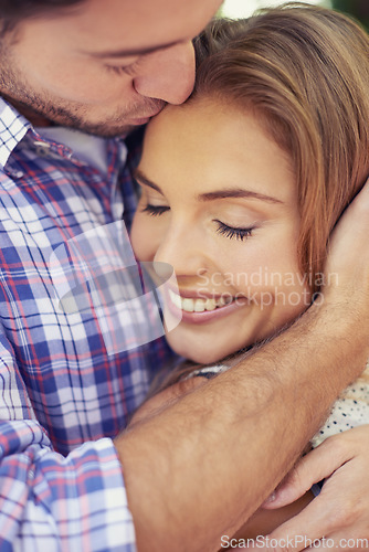 Image of Couple, kiss forehead and hug in park closeup for romantic valentines date, love and happy smile on face. Man, woman and outdoor embrace for dating, adventure together and bonding with care in nature
