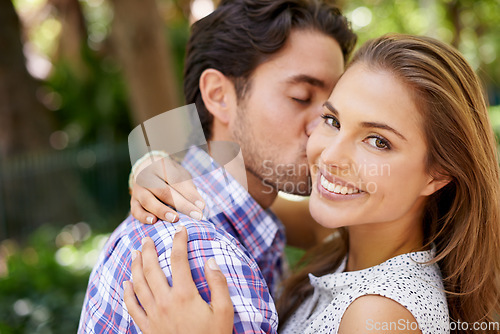 Image of Couple portrait, hug or cheek kiss on romance date, love or valentines day in park, backyard bonding or relax garden. Smile, man or woman embrace in honeymoon trust, support or security on holiday