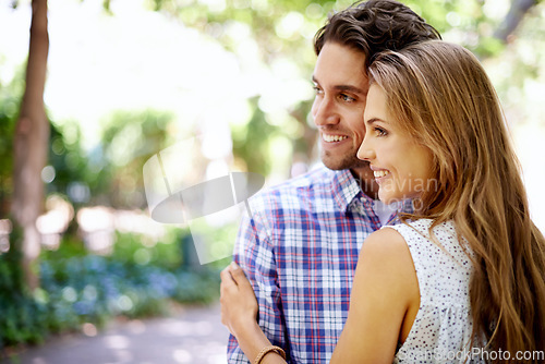 Image of Happy, love and couple at park for valentines date in summer celebration or romance. Young woman, partner or people smile and hug together in garden excited for anniversary in nature or outdoor