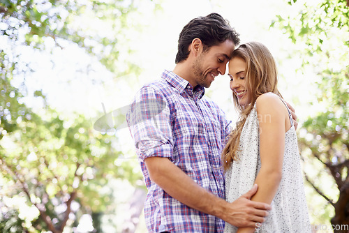 Image of Love, nature and couple in park on valentines day with trees celebrating romantic outdoor forest date. Romance, relationship and man with woman in garden together with happy smile and loving touch.