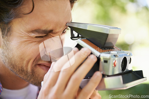 Image of Photography, shooting and man with a vintage camera in nature for a photo and hobby in France. Creative, artistic and zoom on a photographer taking pictures in a park for film and recreation