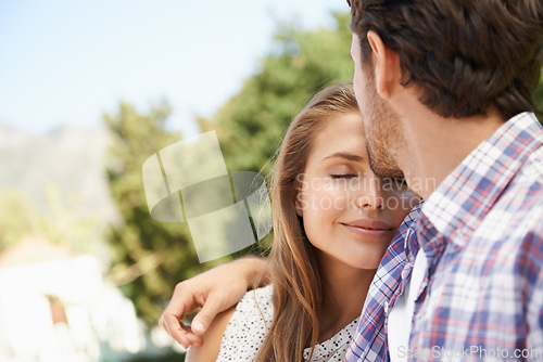 Image of Happy couple, trust or forehead kiss on love date, valentines day or romance bonding in nature, park or relax garden. Smile, woman or man kissing head in intimate security, hug or thank you support