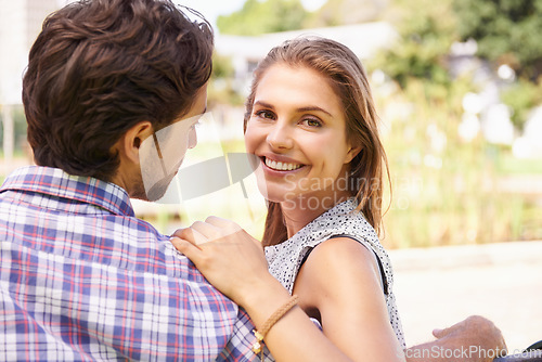 Image of Couple, portrait and bonding on love bench in nature park or city garden on valentines day, romance date or marriage anniversary. Smile, happy woman or man on outdoor seat hug or relax wood furniture