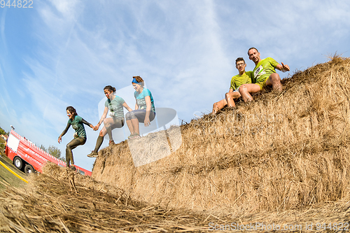 Image of Athletes overcoming the hay osbtacle