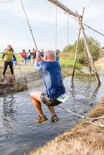 Image of Athlete go through mud and water