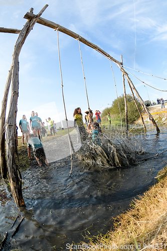 Image of Athletes go through mud and water