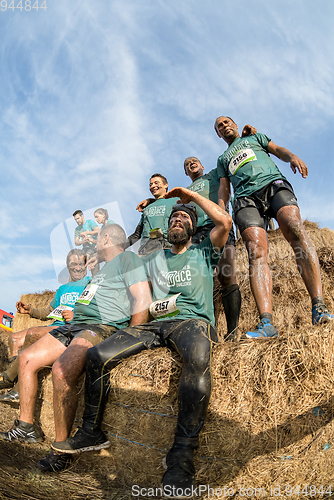 Image of Athletes overcoming the hay osbtacle