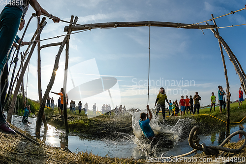 Image of Athletes go through mud and water