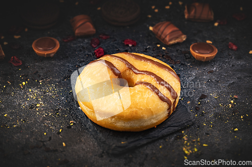 Image of Delicious donut on black slate background