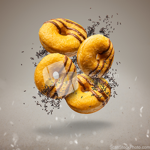 Image of Flying delicious classic donuts