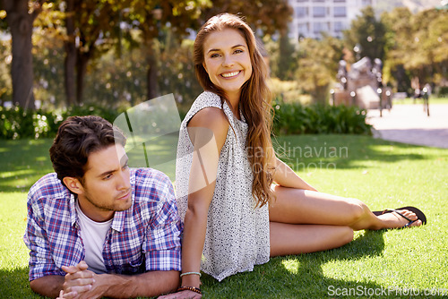 Image of Couple, bonding or love date on grass, nature park or garden on valentines day, romance or anniversary celebration. Smile, happy woman or man in relax environment, summer break or partnership picnic