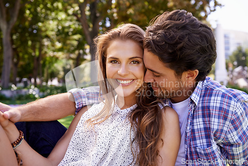 Image of Happy couple, bonding or love date hug on grass, nature park or garden on valentines day, romance or anniversary celebration. Smile, woman or man in relax environment, support or partnership picnic