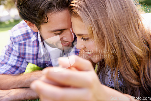 Image of Happy couple, bonding or love date on grass, nature park or garden on valentines day, romance or anniversary celebration. Smile, woman or man in relax environment, summer break or partnership picnic