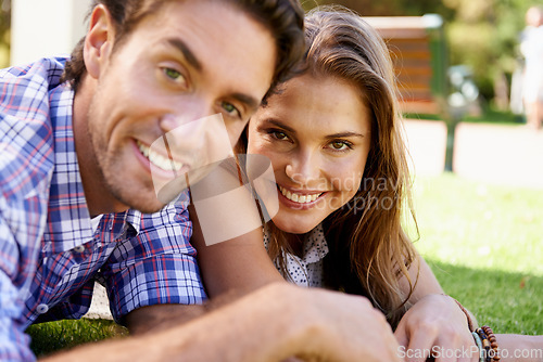 Image of Happy couple, portrait or love date on grass, nature park or garden bonding on valentines day, romance or anniversary celebration. Smile, woman or man lying in relax environment or partnership picnic