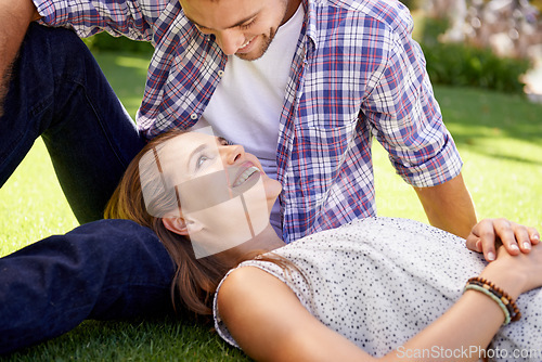 Image of Bonding couple, lying and love on grass, nature park or garden on valentines day, romance date or marriage bonding. Smile, happy woman and man in relax environment, summer rest or partnership picnic