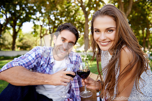 Image of Couple portrait, wine or love toast on picnic date, valentines day or romance bonding in nature park or garden. Smile, happy woman or man and alcohol drinks glass for marriage anniversary celebration