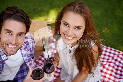 Image of Portrait, top view and couple in picnic, wine and Valentines date with smile, loving and quality time outdoor. Romantic, man and woman in park, celebration for anniversary and love on summer vacation