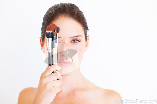 Image of Woman, face and brush for makeup in portrait, beauty and cosmetics isolated on white background. Mockup space, female in studio with cosmetic tools in hand and skincare, dermatology glow and wellness
