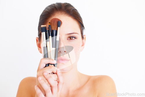 Image of Woman, face and makeup tools in portrait, beauty and cosmetics isolated on white background. Mockup space, female in studio with cosmetic brush in hands and skincare, dermatology glow and wellness