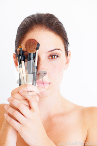 Image of Woman, face and makeup brush in hands, portrait and beauty with cosmetics isolated on white background. Cosmetology, female in studio with cosmetic tools and skincare, dermatology glow and wellness