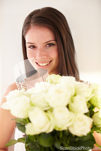 Image of Portrait, woman and bouquet of flowers for celebration, happiness and achievement with smile, gift or beauty. Face, confident female or happy lady with white roses, floral present or romantic gesture