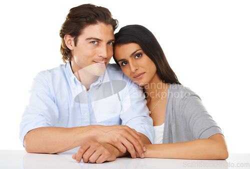 Image of Portrait, love and couple together in a studio with white background and hand holding. Sitting, studio and smile of a young man and woman from Israel in marriage with casual fashion and connection