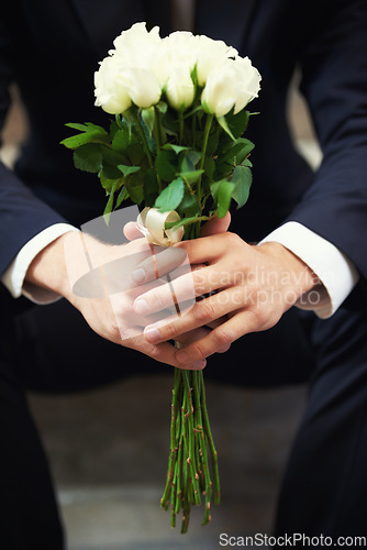 Image of Hands, flowers and man on wedding day waiting for ceremony of love, tradition or romance closeup. Floral bouquet, marriage and commitment with a groom sitting outdoor alone at a celebration event