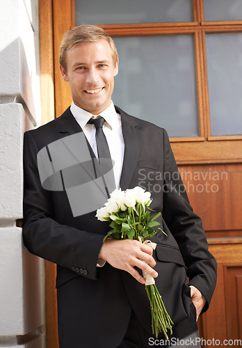 Image of Love, portrait and man with flowers for valentines day, romance or gesture while standing against a wall background. Roses, happy and gentleman with bouquet for sweet, anniversary gift or first date