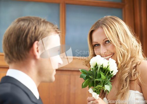 Image of Couple, flowers and woman with smile in valentines day, relationship or celebration for date. Happy female holding white roses, bouquet or gift from boyfriend for anniversary or special month of love