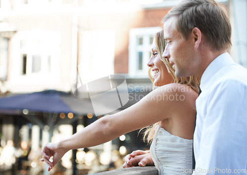 Image of Wedding couple, city and love of happy people together on a bridge with a smile and care. Loving celebration, date and pointing woman with husband celebrating marriage, connection and anniversary