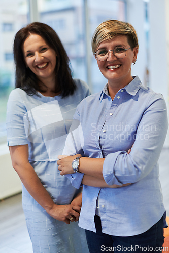 Image of Portrait of a two teacher in a preschool institution, in the background of the classrooms