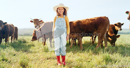 Image of Happy, girl and farm, cow and sustainability in agriculture with a smile for growth, freedom and portrait. Countryside child, smile or kid in a field of grass, cattle and ecology livestock animals