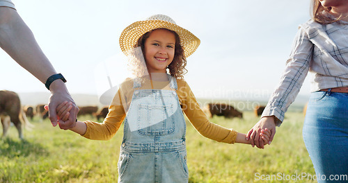 Image of Farmer, family and girl with parents at cattle farm, holding hands and learning about livestock, family business and sustainable living. Love, agriculture and happy family bonding in nature with cows