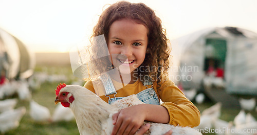 Image of Chicken, smile and girl on a farm learning about agriculture in the countryside of Argentina. Happy, young and sustainable child with an animal, bird or rooster on a field in nature for farming