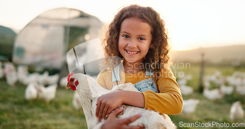 Image of Chicken, smile and girl on a farm learning about agriculture in the countryside of Argentina. Happy, young and sustainable child with an animal, bird or rooster on a field in nature for farming