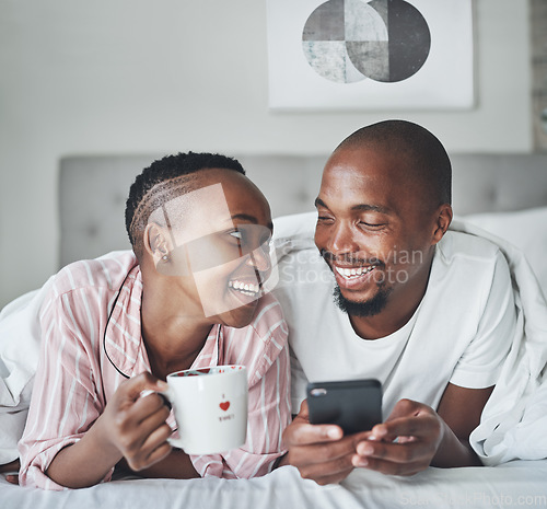 Image of Black couple in bed with smartphone, coffee and happiness with morning routine, social media or streaming online. Wifi, communication and technology with happy man and woman, relax at home together