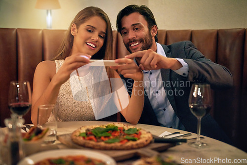 Image of Restaurant, couple and phone for photo of food, pizza or romantic date night meal for valentines day. Social media, picture and influencer man with woman on smartphone for blog, review or eating post