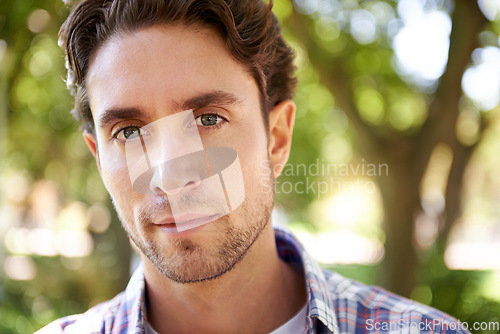 Image of Portrait, man and in park to relax, sunshine and happiness on weekend break, calm and peaceful. Face, male and gentleman in nature, forest and summer on vacation, casual day and guy outdoor with joy